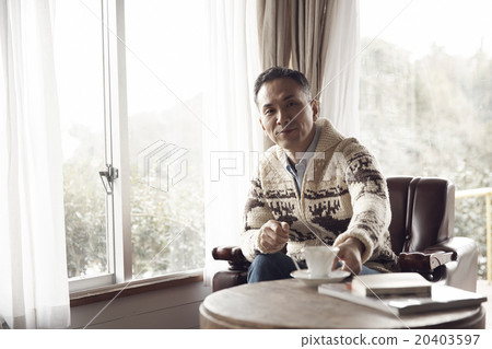 A man sitting by the window 20403597