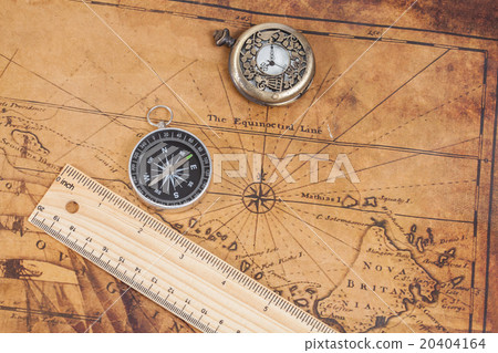 Old style brass compass on antique map 20404164