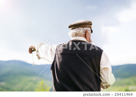Old farmer on the meadow 20411464