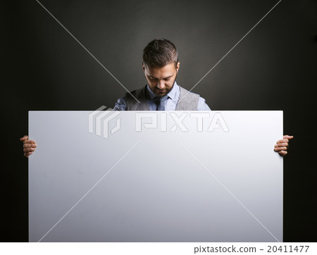 Hipster businessman with blank advertisement Hipster businessman with blank advertisement 20411477