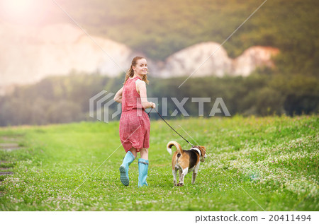 Young woman in wellies walk her dog Young woman in wellies walk her dog 20411494
