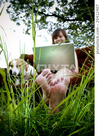 Woman with laptop in fied Woman with laptop in fied 20412407