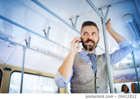 Hipster businessman with mobile phone on tram 20412812