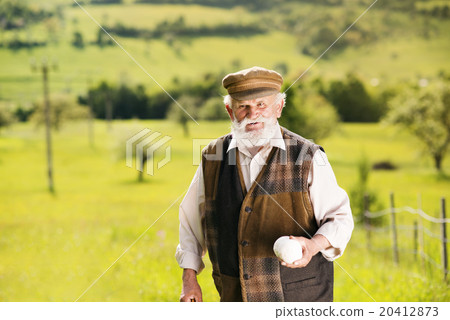 Old farmer on the meadow Old farmer on the meadow 20412873