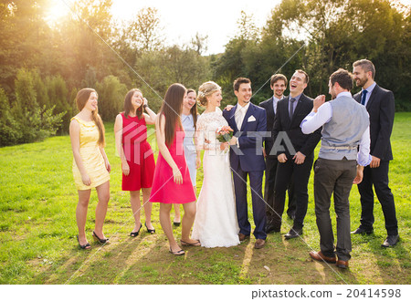 Newlyweds with guest posing in park Newlyweds with guest posing in park 20414598