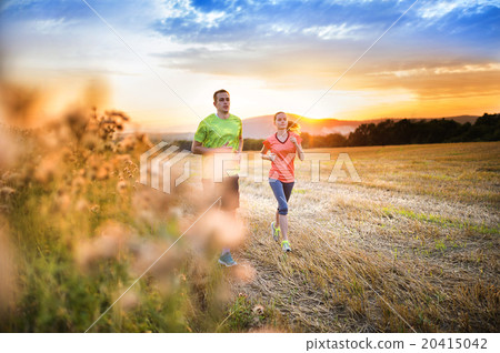 Couple running at sunset Couple running at sunset 20415042