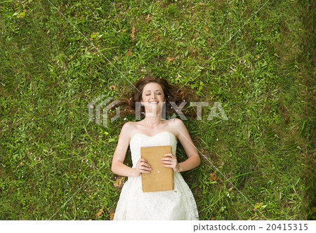Girl lying on grass 20415315