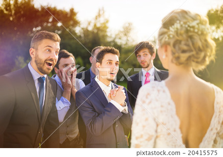 Groomsmen looking at bride Groomsmen looking at bride 20415575