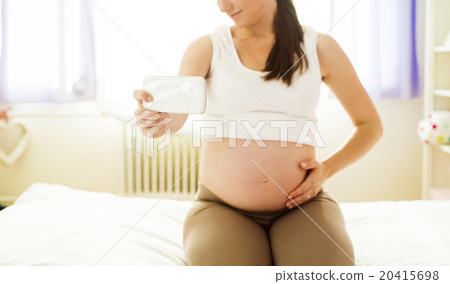 Pregnant woman with mobile phone Pregnant woman with mobile phone 20415698