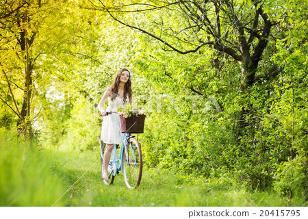 Young woman with bike Young woman with bike 20415795