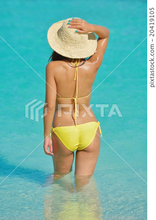 pretty woman resting on tropical beach 20419105