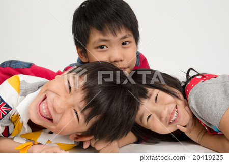 Happy asian family hugging on gray background 20419225