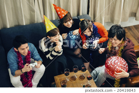 Men and women enjoying home parties Men and women enjoying home parties 20419843