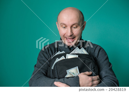 excited businessman holding bag with money and smiling excited businessman holding bag with money and smiling 20428819
