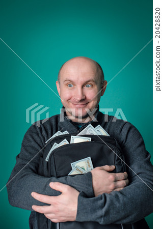 excited businessman holding bag with money and smiling 20428820