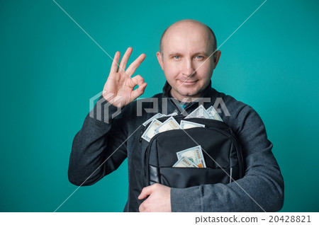 excited businessman holding bag with money and smiling 20428821