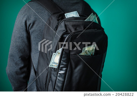 man with a black backpack from which protrude dollars 20428822