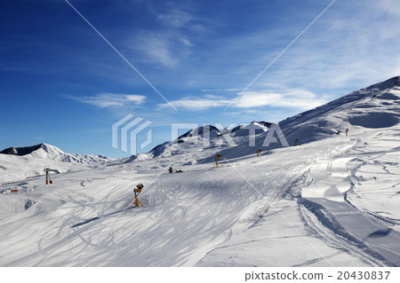 Ski slope with snowmaking at sun morning 20430837