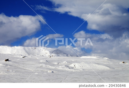 Ice-covered slope and snowy mountains in fog 20430846