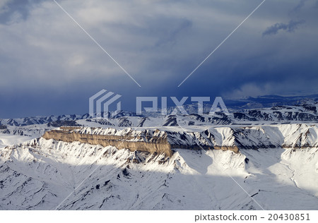 Winter mountains at sun evening and gray clouds 20430851