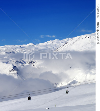 Off-piste snowy slope and cable car at sun day 20430889