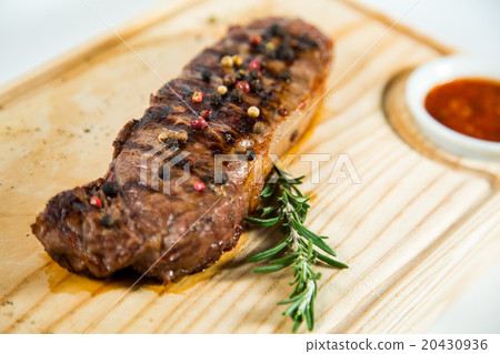 Beautiful juicy well done steak with sauce 20430936