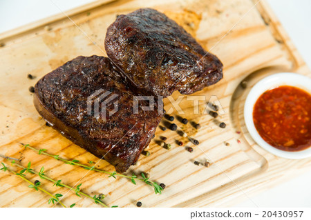 Beautiful juicy well done steak with sauce 20430957