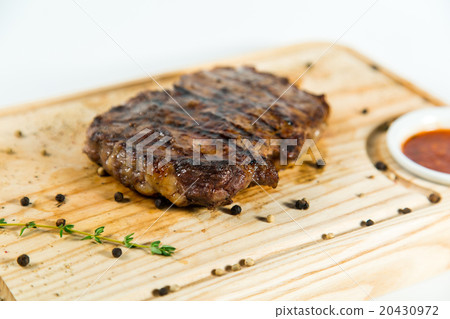 Beautiful juicy well done steak with sauce 20430972