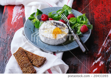 Goat cheese with honey and raspberries Goat cheese with honey and raspberries 20431093