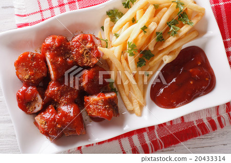 Currywurst and fries close-up on a plate Currywurst and fries close-up on a plate 20433314