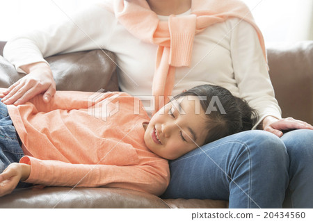 A girl sleeping on her mother's knee pillow 20434560