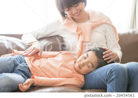 A girl sleeping on her mother's knee pillow 20434561