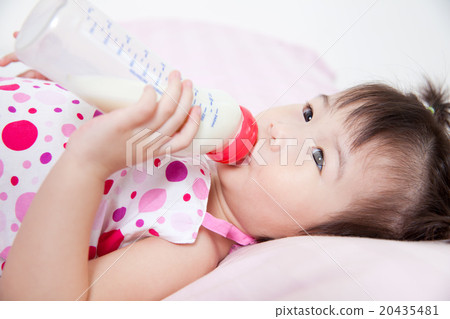 Beautiful little asian girl lying and suck up milk Beautiful little asian girl lying and suck up milk 20435481