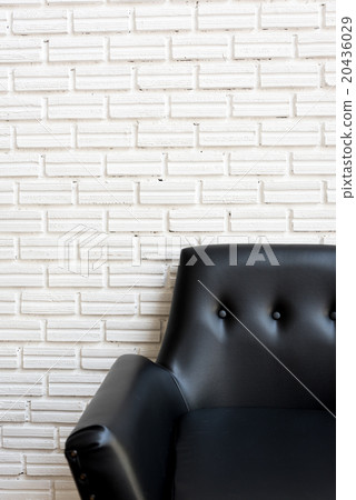 Close up classic black sofa and white brick wall 20436029