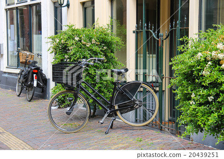 Parked bicycles near the old houses  20439251
