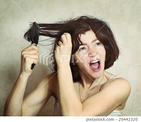 woman try to comb hairs woman try to comb hairs 20442320