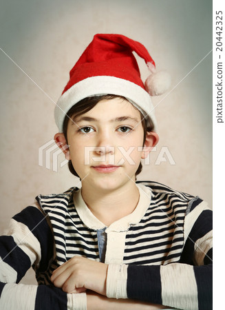 close up portrait of a preteen boy in santa hat  20442325