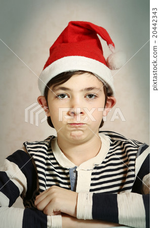 close up portrait of a preteen boy in santa hat close up portrait of a preteen boy in santa hat 20442343