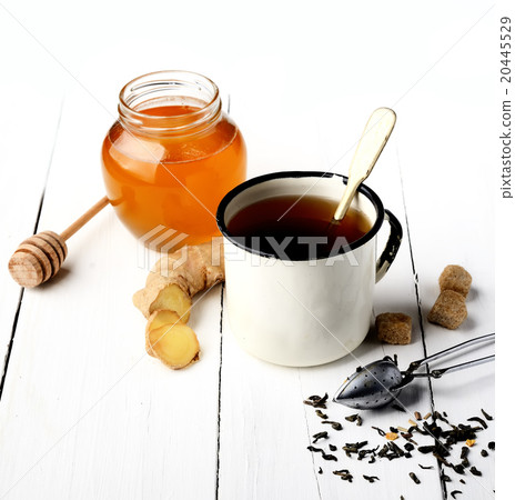 tea in white metal mug, ginger, sugar and honey on tea in white metal mug, ginger, sugar and honey on 20445529