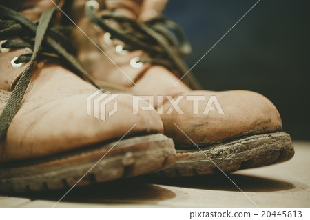 Old and Dirty boots in mud 20445813