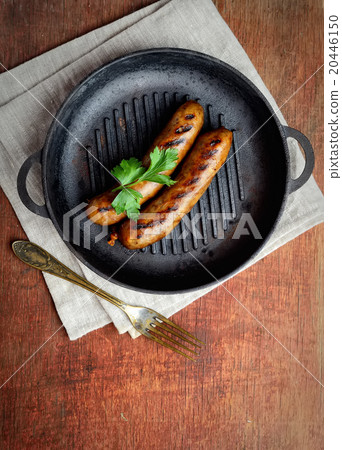 Two meat sausages in a pan 20446150