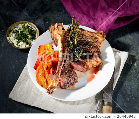 steak on a plate with grilled vegetables and sauce 20446948