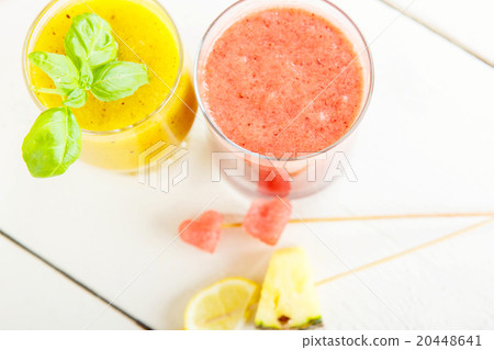 red and yellow smoothie with different fruits and red and yellow smoothie with different fruits and 20448641