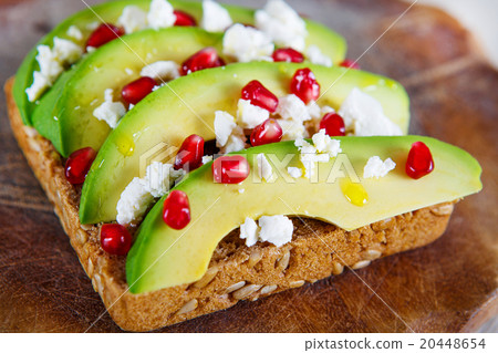 Avocado with Feta, pomegranate on sunflower seeds Avocado with Feta, pomegranate on sunflower seeds 20448654