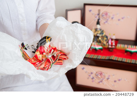 A woman decorating a doll doll (mother) A woman decorating a doll doll (mother) 20448729