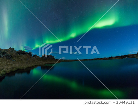 Aurora borealis in Iceland above a lake with boat 20449131