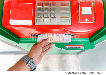 Collecting thai 1000 baht notes at ATM machine. Collecting thai 1000 baht notes at ATM machine. 20452676