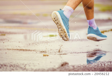 Young man running in rainy weather Young man running in rainy weather 20456212