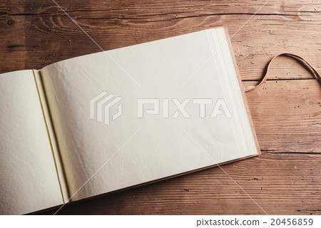Photo album on wooden desk 20456859