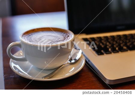 Laptop on Vintage Wooden desktop in modern office 20458408